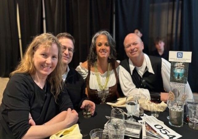 A group of people sitting at a table.